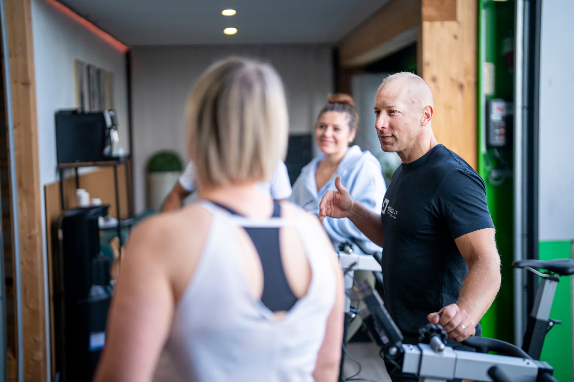 Gym owner coaching a member on the training floor