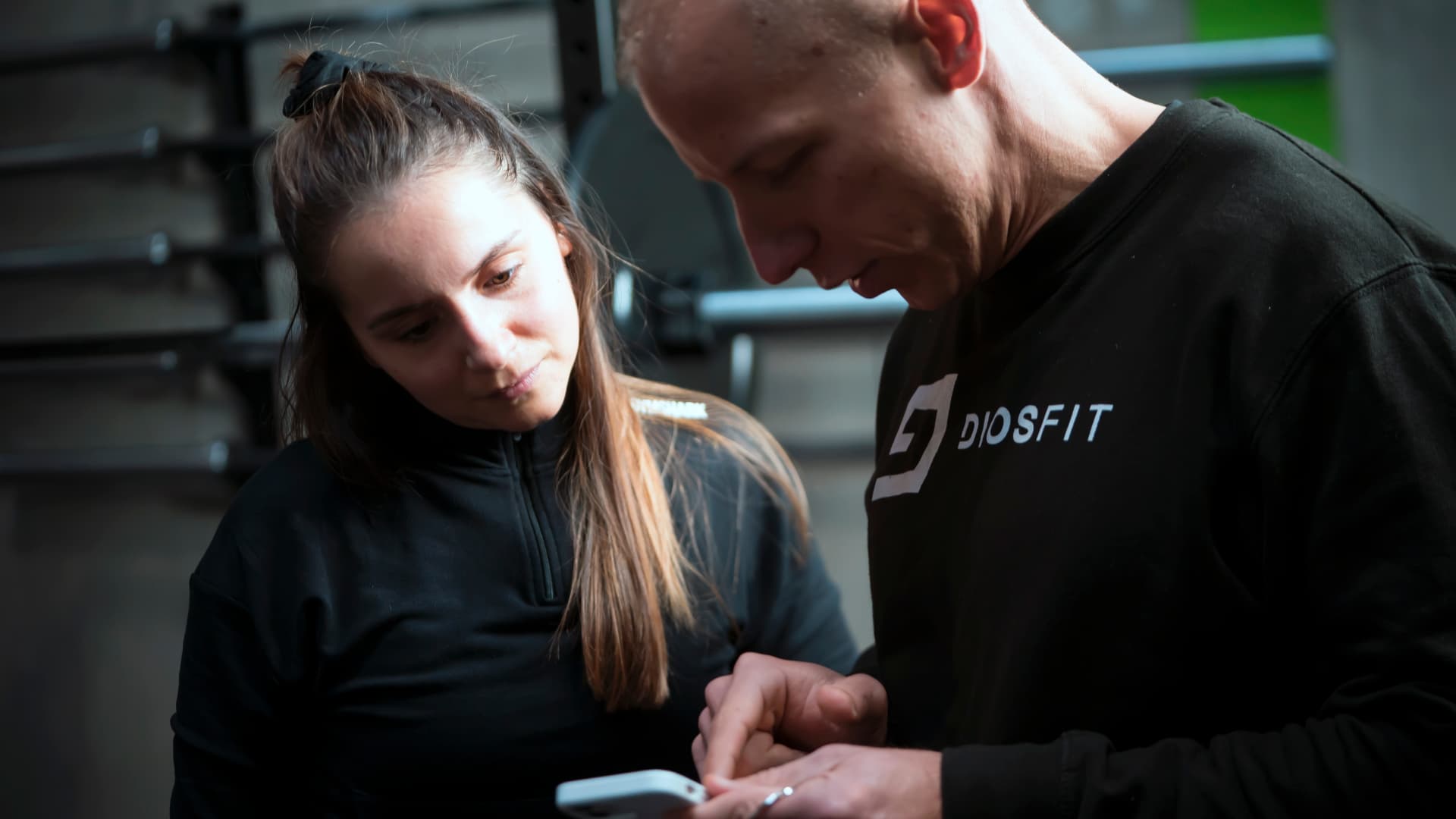 Coach reviewing progress with a gym member